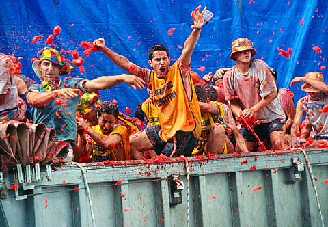 Revellers throw tomatoes from a truck during the annual festival of La Tomatina  Bunol, Valencia, Spain
