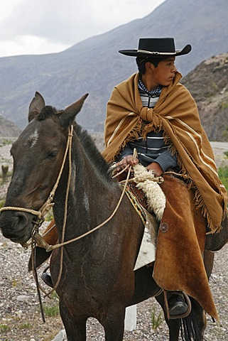 Portrait of a northern gaucho riding a horse near Purmamarca, Quebrada de Humahuaca, Jujuy province, Argentina, South America